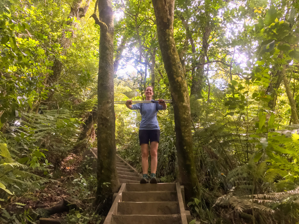 Julia Squeezes through a narrow gap in the trees - Te Araroa Tra