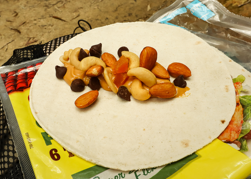 wrap filled with nuts, fruit and peanut butter is a great hiking lunch idea