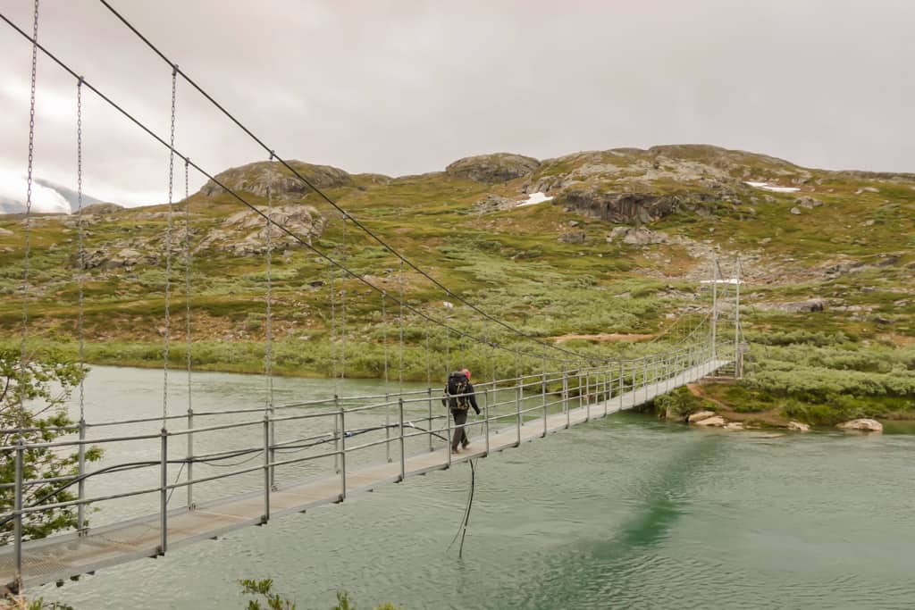 crossing a hanging bridge on the kungsleden one of the best thru hikes in europe